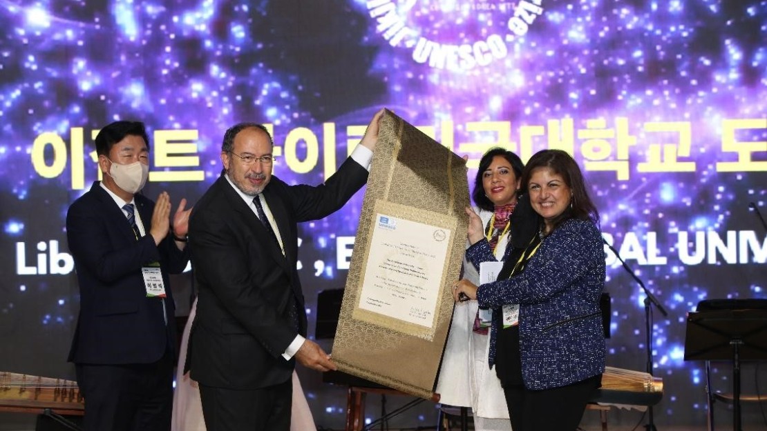 Group of people receiving award on stage